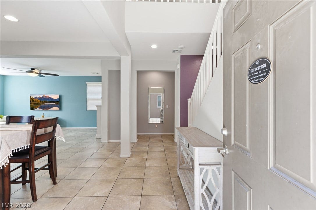 A welcoming entryway with tile flooring transitions to a bright, open living space.