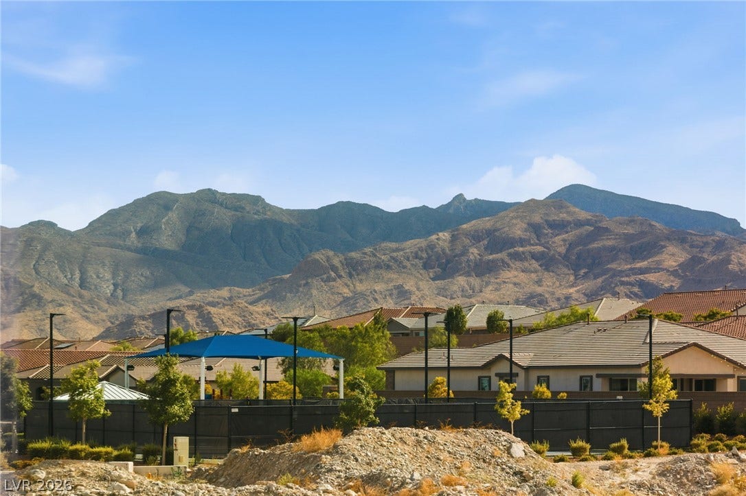Dramatic mountain vistas backdrop this residential community, featuring a covered outdoor area.