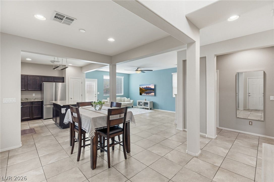An open-concept design seamlessly connects the kitchen, dining, and living areas, creating a flowing and versatile interior.