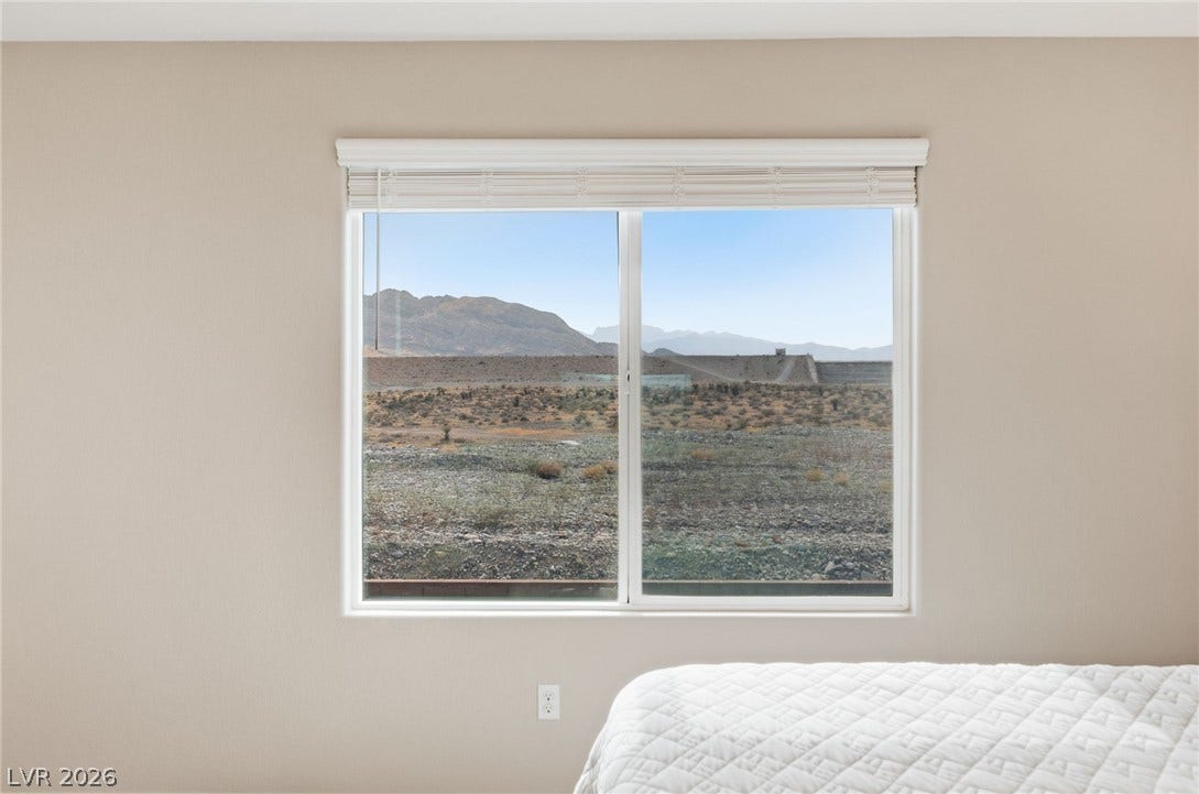 A well-placed window captures vast desert and mountain views, inviting the landscape indoors.