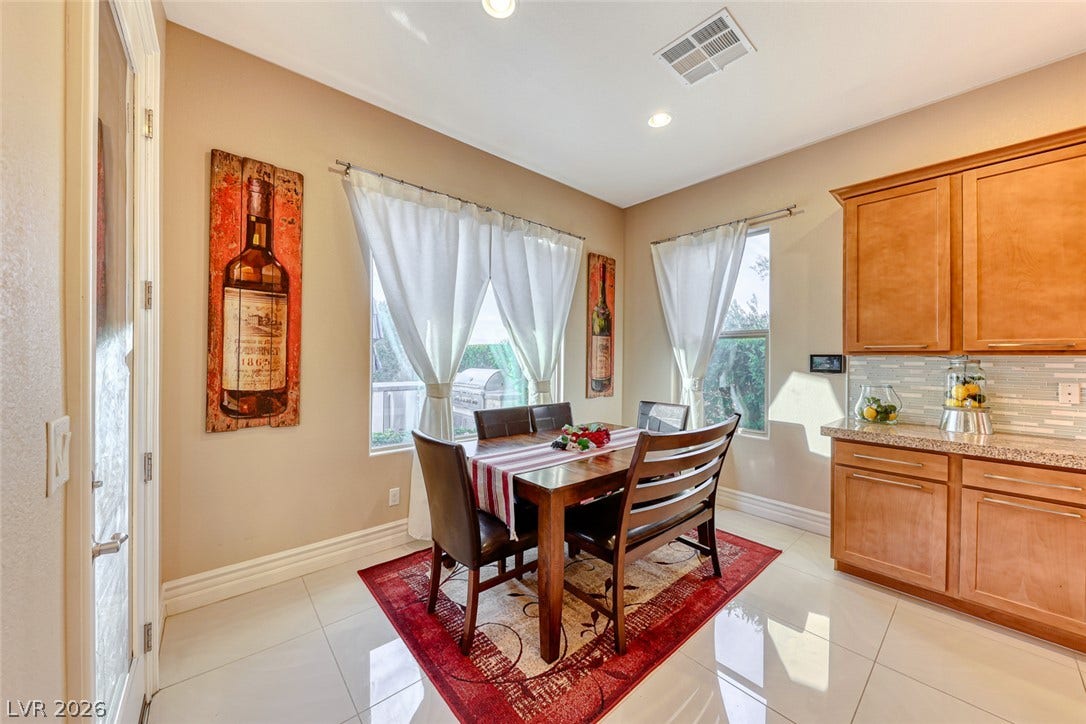 70 Portezza Drive, Henderson, NV 89011 A naturally illuminated dining area seamlessly integrates with a functional kitchen space.