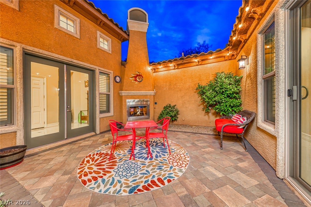 70 Portezza Drive, Henderson, NV 89011 An inviting courtyard with paver flooring and an outdoor fireplace creates a perfect private oasis.