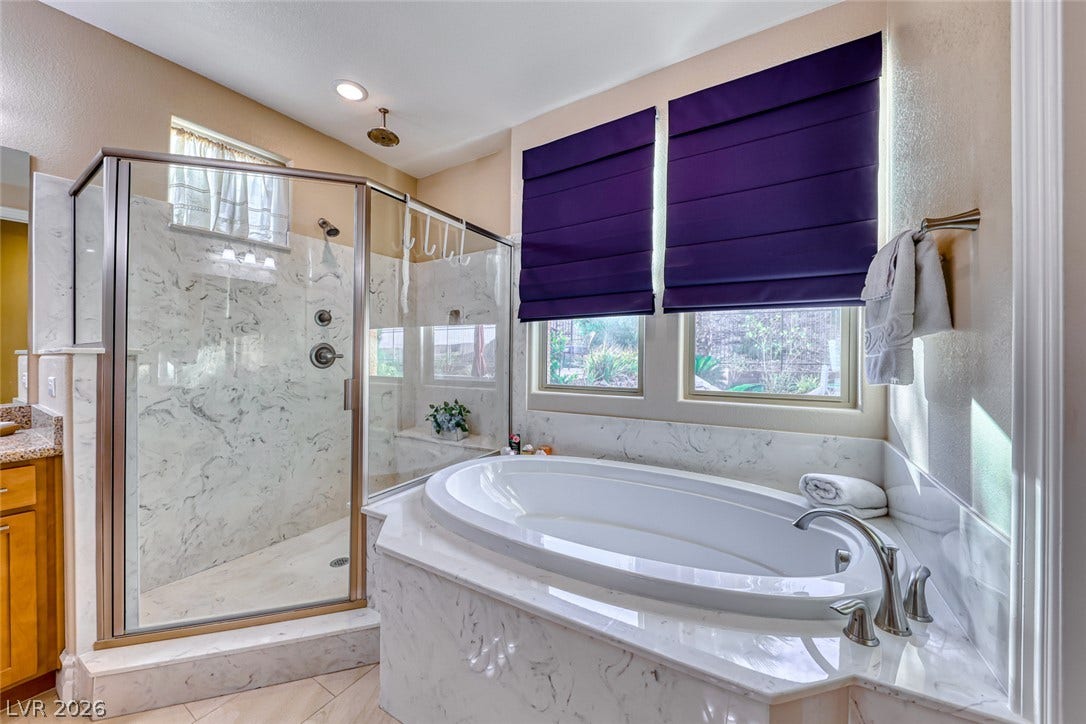 70 Portezza Drive, Henderson, NV 89011 Luxurious soaking tub and spacious shower create a serene bathing retreat.