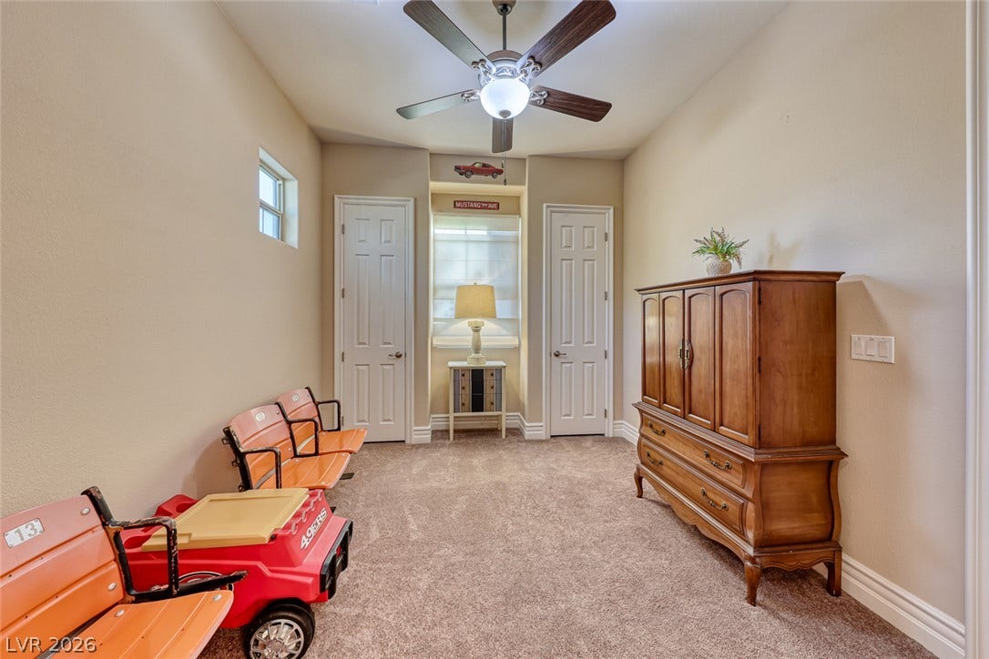 70 Portezza Drive, Henderson, NV 89011 A well-lit interior space with plush carpeting offers versatile living possibilities.