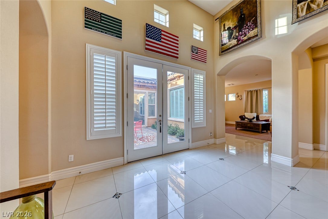 70 Portezza Drive, Henderson, NV 89011 A grand entrance welcomes all with glossy tiled floors and sun-filled arched windows.