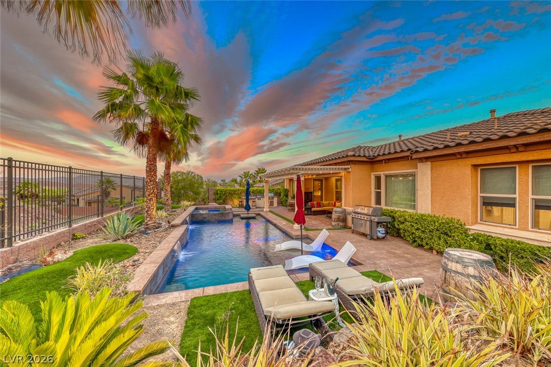 70 Portezza Drive, Henderson, NV 89011 An inviting backyard oasis offers a sparkling pool and spa, perfect for enjoying sunset views.