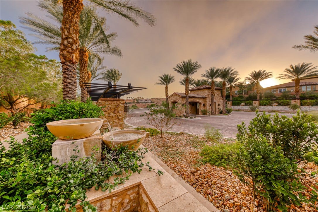 70 Portezza Drive, Henderson, NV 89011 A tranquil stone fountain graces the entry to this beautifully landscaped community with elegant architecture.