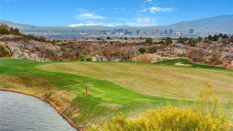 A picturesque golf course setting with an urban skyline backdrop, offering both tranquility and city views.