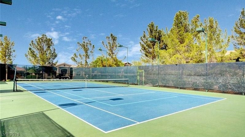 An inviting blue tennis court, perfectly maintained, awaits your next match.