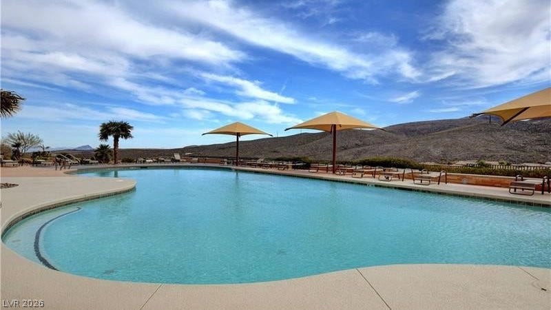 An inviting in-ground pool offers relaxation and recreation against a desert mountain backdrop.