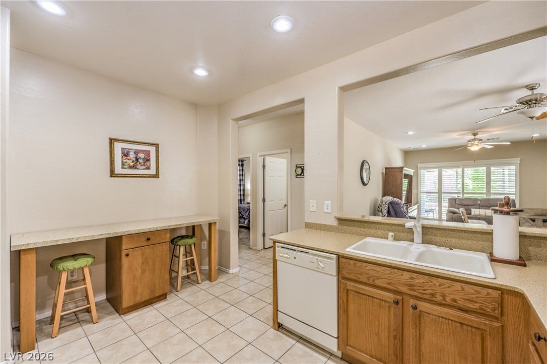 2439 Erastus Drive, Henderson, NV 89044 Kitchen with Upgraded Cabinets, Corian Counters, Recessed Lighting, Pantry, Tile Flooring,Refrigerator, Gas Stove, Dishwasher, andMicrowave