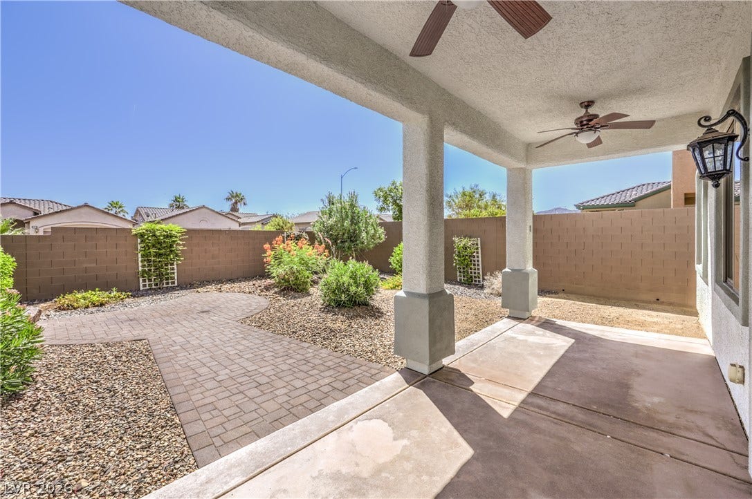 260 Quail Ranch Drive, Henderson, NV 89015 An inviting covered patio extends to a brick-paved path, leading to a landscaped private yard.