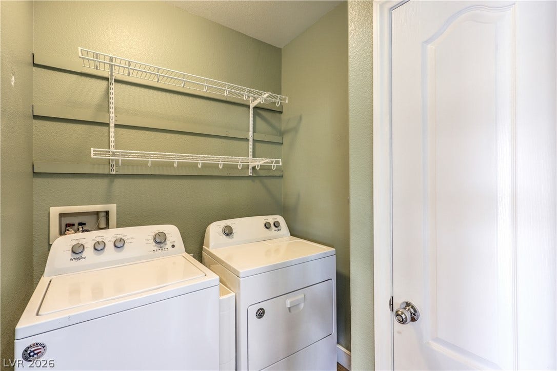 260 Quail Ranch Drive, Henderson, NV 89015 A dedicated laundry space provides practical convenience with overhead shelving and a modern washer and dryer.