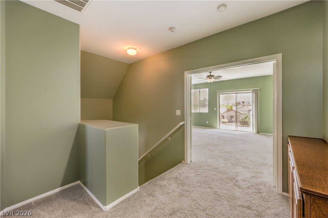 260 Quail Ranch Drive, Henderson, NV 89015 A welcoming landing area with plush carpet leads to the primary bedroom featuring outdoor access.