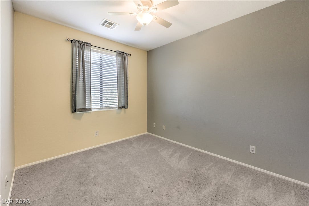260 Quail Ranch Drive, Henderson, NV 89015 A comfortable bedroom with soft carpeting and a ceiling fan for climate control.