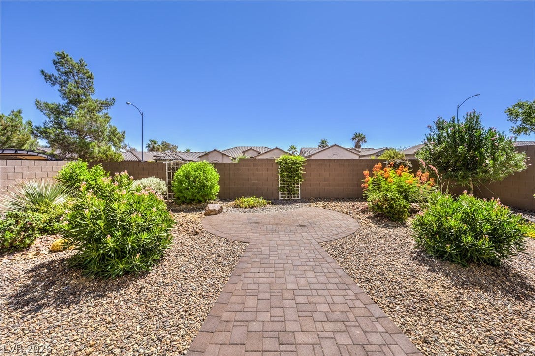 260 Quail Ranch Drive, Henderson, NV 89015 A private yard with a paver patio and lush, low-maintenance landscaping awaits outdoor enjoyment.