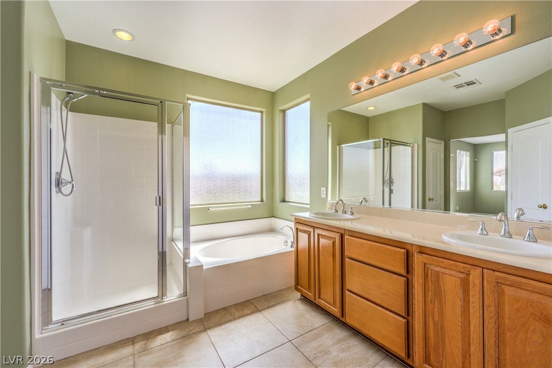 260 Quail Ranch Drive, Henderson, NV 89015 Double vanities and a soaking tub create a personal spa retreat in this well-appointed bathroom.