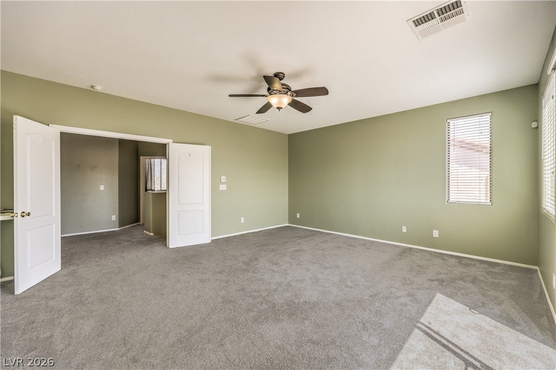 260 Quail Ranch Drive, Henderson, NV 89015 The spacious primary bedroom offers comfortable gray carpeting and natural illumination from multiple windows.