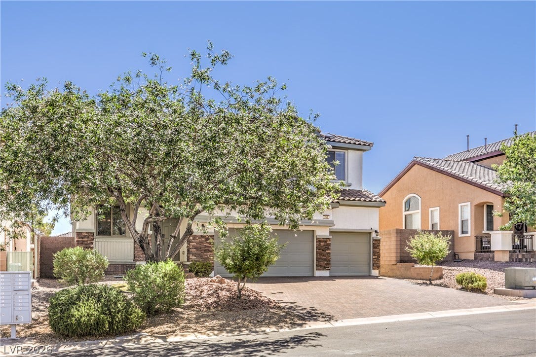 260 Quail Ranch Drive, Henderson, NV 89015 A welcoming facade with a tiled roof, paver driveway, and well-maintained desert landscaping.