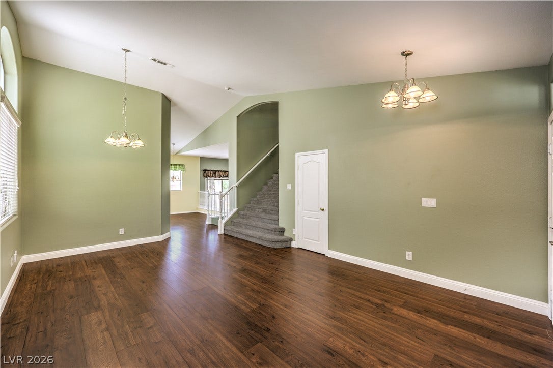 260 Quail Ranch Drive, Henderson, NV 89015 Rich wood flooring complements the vaulted ceiling and elegant lighting in this inviting living area.