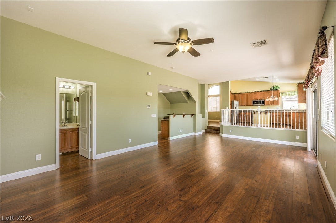 260 Quail Ranch Drive, Henderson, NV 89015 Rich wood flooring flows through this airy living area, featuring an adjacent kitchen, and a convenient powder room access.