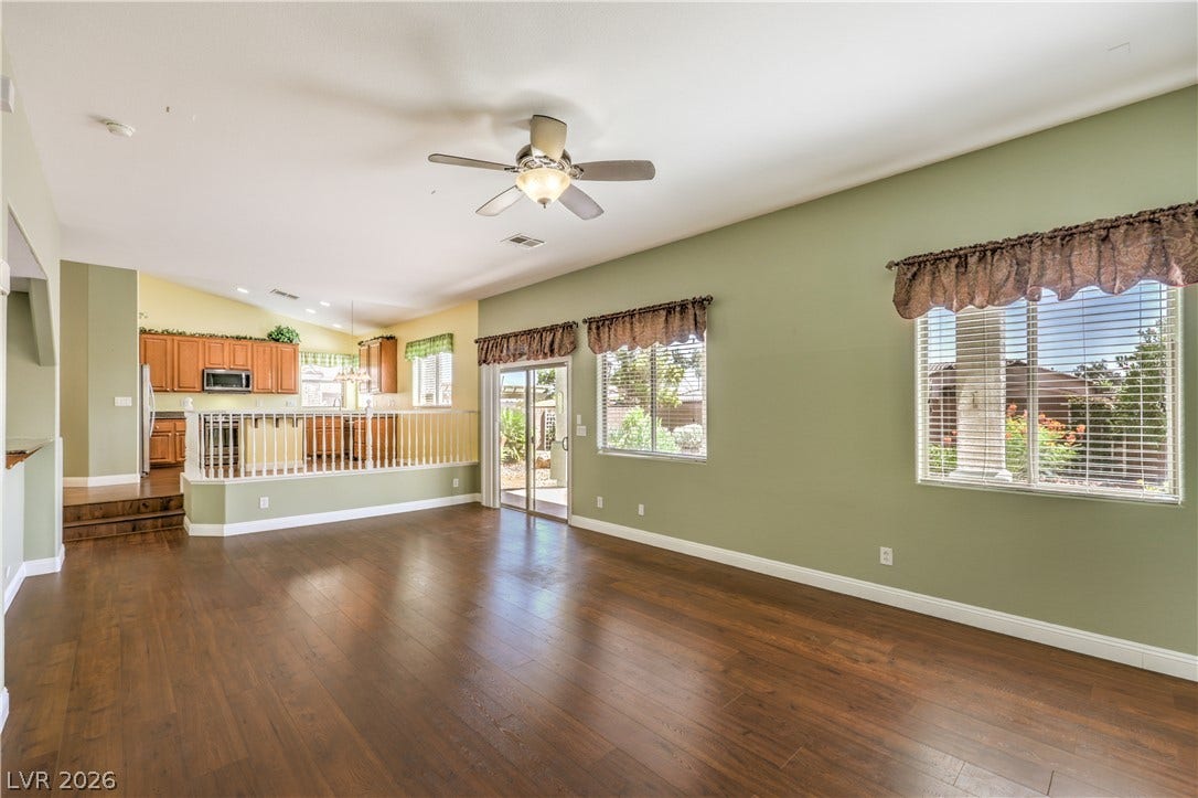 260 Quail Ranch Drive, Henderson, NV 89015 An inviting open-concept living space features warm wood flooring and a view into the kitchen.
