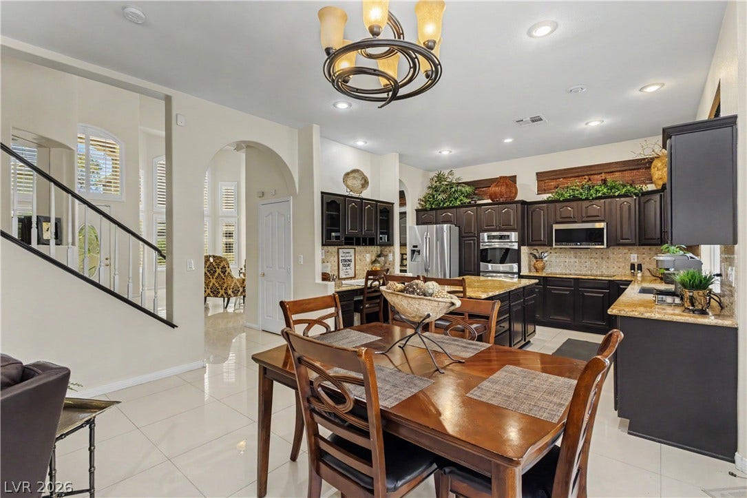 118 Serramonte Court, Henderson, NV 89074 An open-concept living space integrates a well-appointed kitchen with an elegant dining area, all under soft recessed lighting.