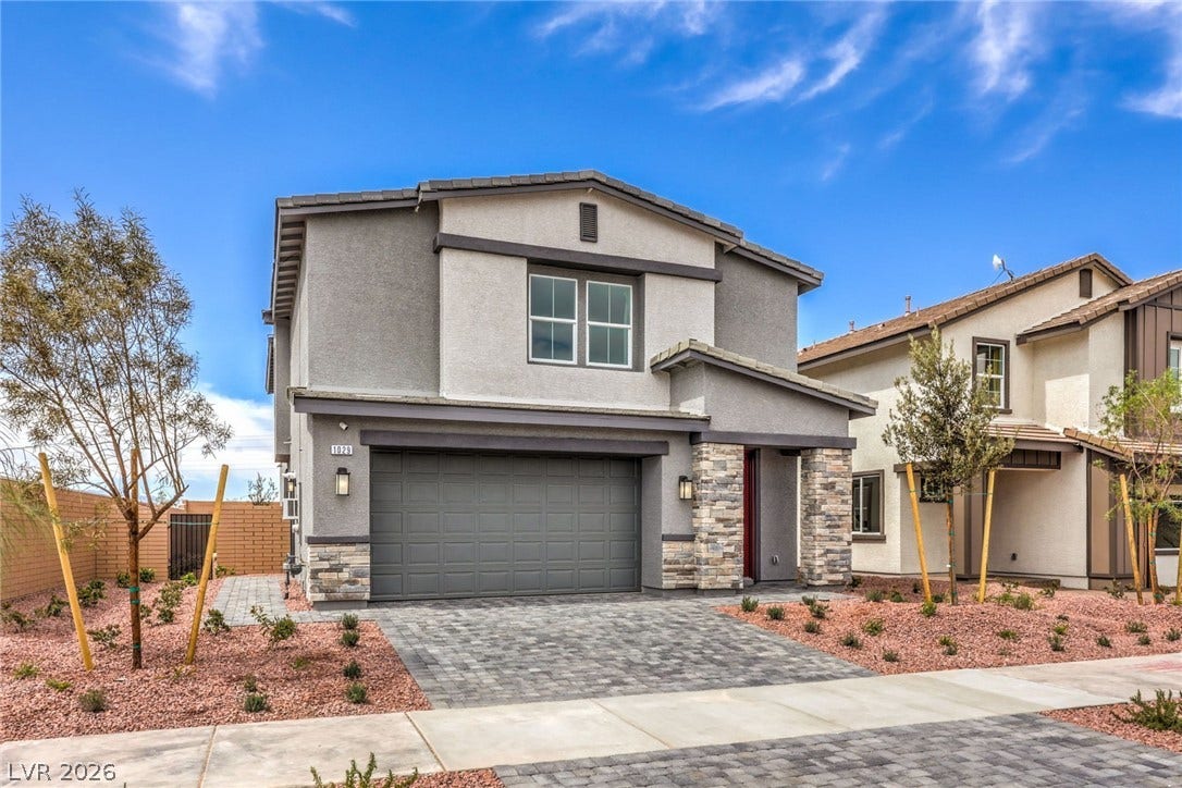 1030 PEACOCK PLUME Avenue, Henderson, NV 89011 Photo is representational only; actual home finishes may vary. Traditional-style home with an attached garage, stone siding, decorative driveway, and stucco siding