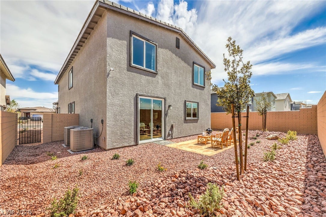1030 PEACOCK PLUME Avenue, Henderson, NV 89011 Photo is representational only; actual home finishes may vary. Rear view of property featuring stucco siding, a fenced backyard, and cooling unit