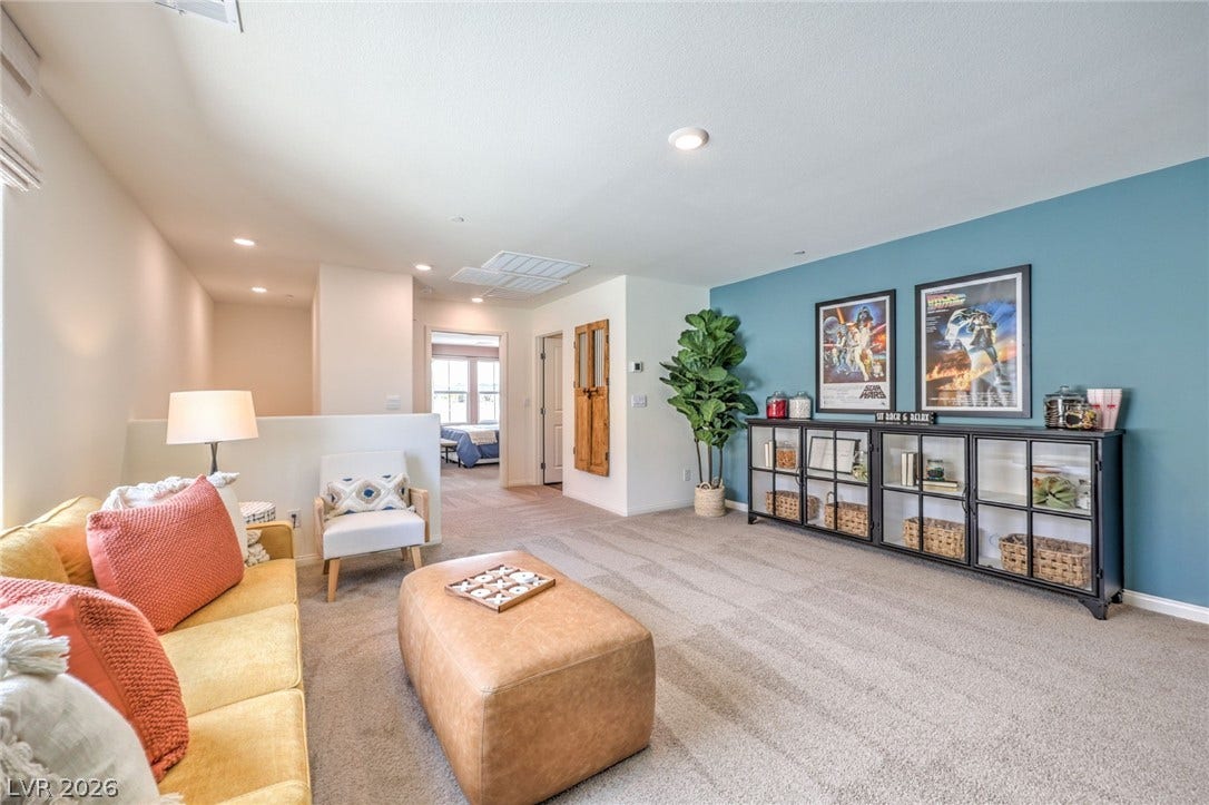 1030 PEACOCK PLUME Avenue, Henderson, NV 89011 Carpeted living area with recessed lighting and baseboards. Photo is representational only; actual home finishes may vary.