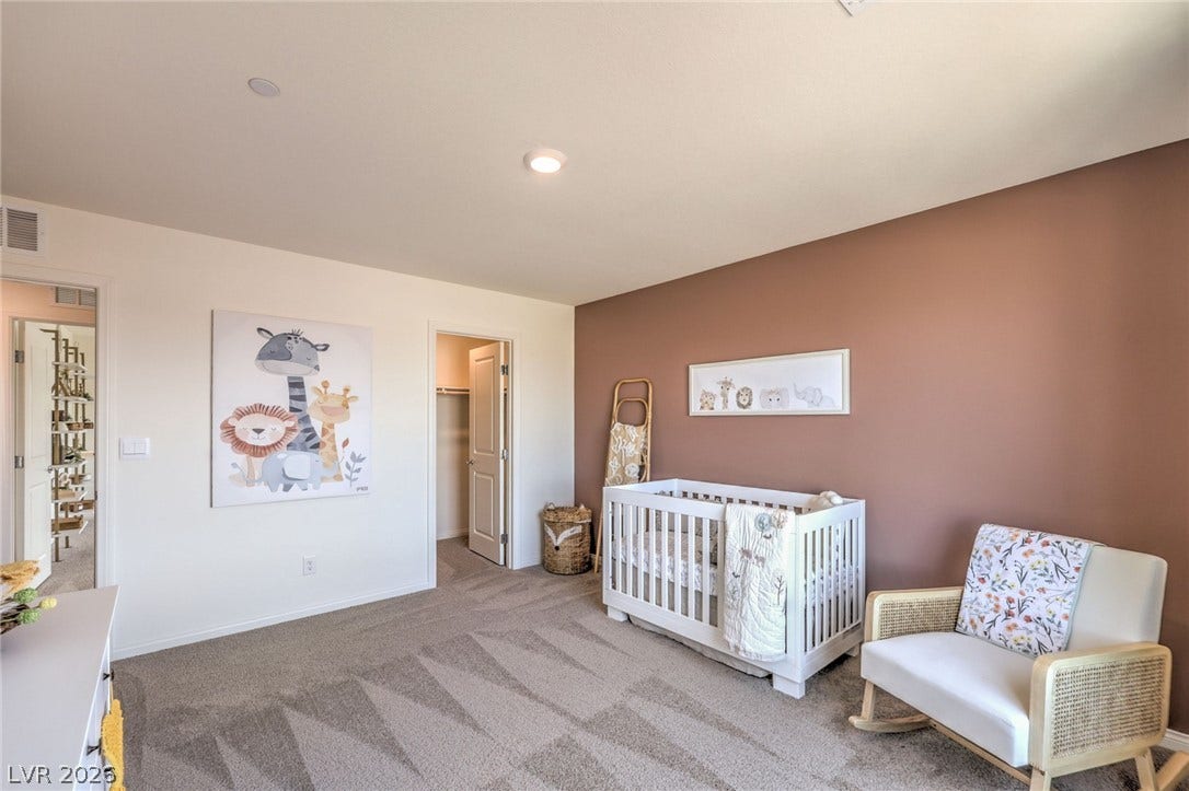 1030 PEACOCK PLUME Avenue, Henderson, NV 89011 Bedroom featuring carpet, baseboards, and a spacious closet. Photo is representational only; actual home finishes may vary.