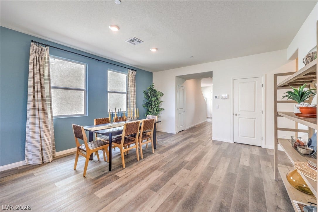 1030 PEACOCK PLUME Avenue, Henderson, NV 89011 Photo is representational only; actual home finishes may vary. Dining area featuring light wood-style flooring and baseboards