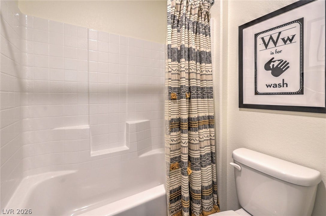 1030 PEACOCK PLUME Avenue, Henderson, NV 89011 Photo is representational only; actual home finishes may vary. Bathroom with toilet and shower / bath combo