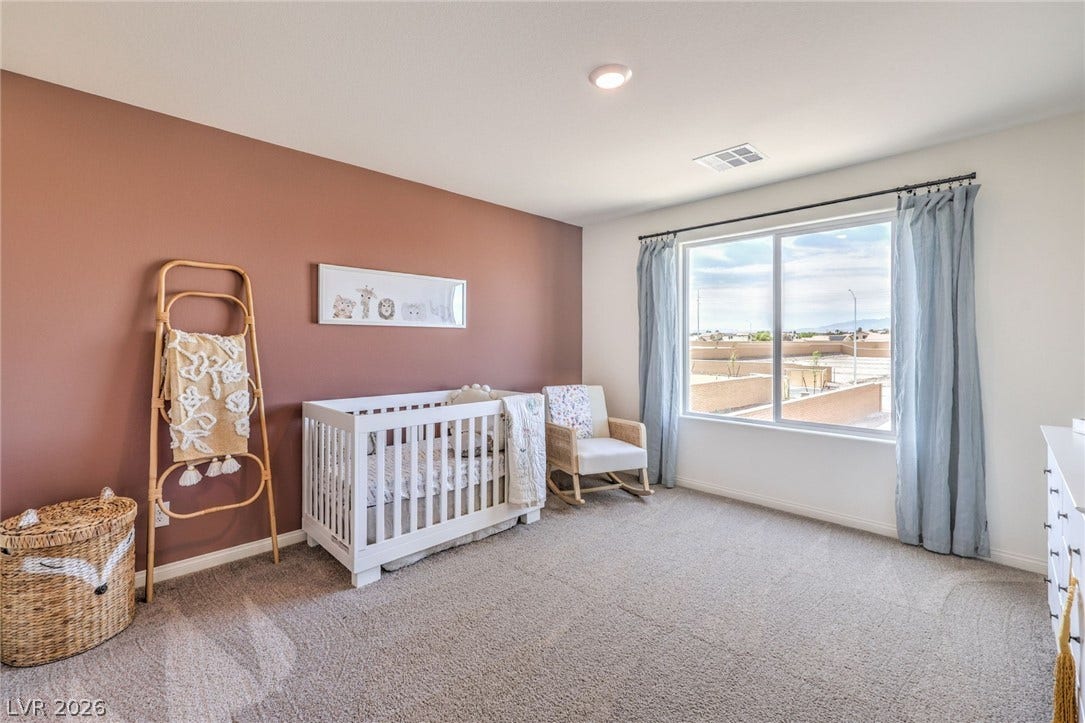 1030 PEACOCK PLUME Avenue, Henderson, NV 89011 Photo is representational only; actual home finishes may vary. Carpeted bedroom featuring baseboards and a crib