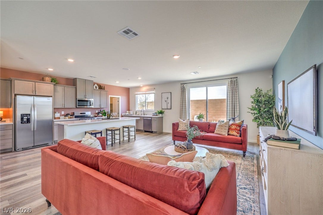 1030 PEACOCK PLUME Avenue, Henderson, NV 89011 Living room with light wood-type flooring and recessed lighting. Photo is representational only; actual home finishes may vary.