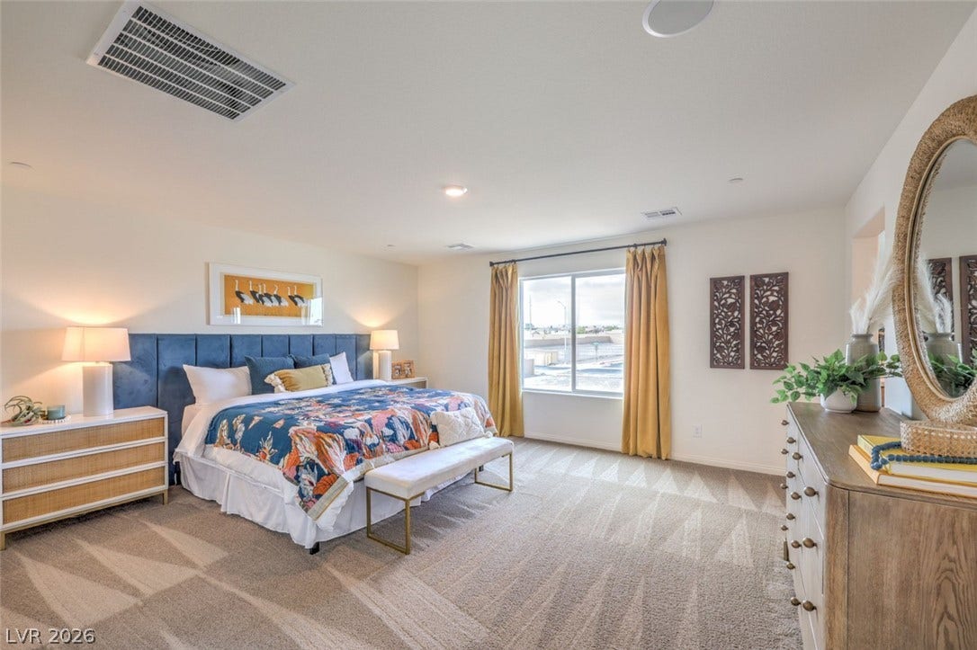 Bedroom featuring baseboards, visible vents, and carpet flooring.Photos are of a model home and are for representational purposes only.