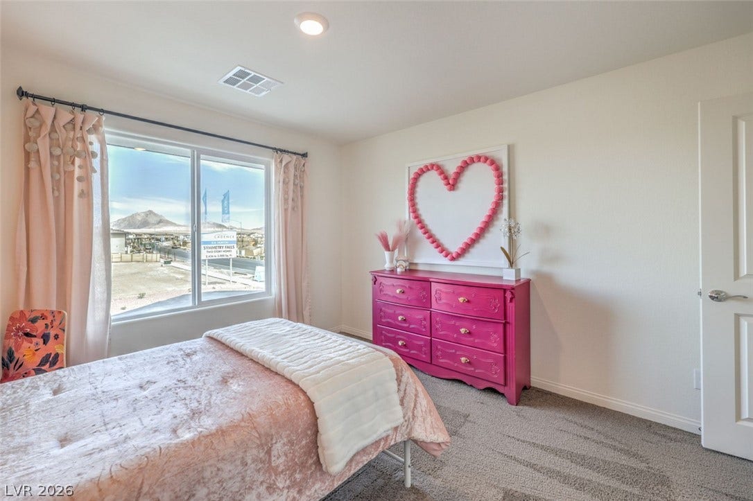 Bedroom with carpet, baseboards, and visible vents.Photos are of a model home and are for representational purposes only.