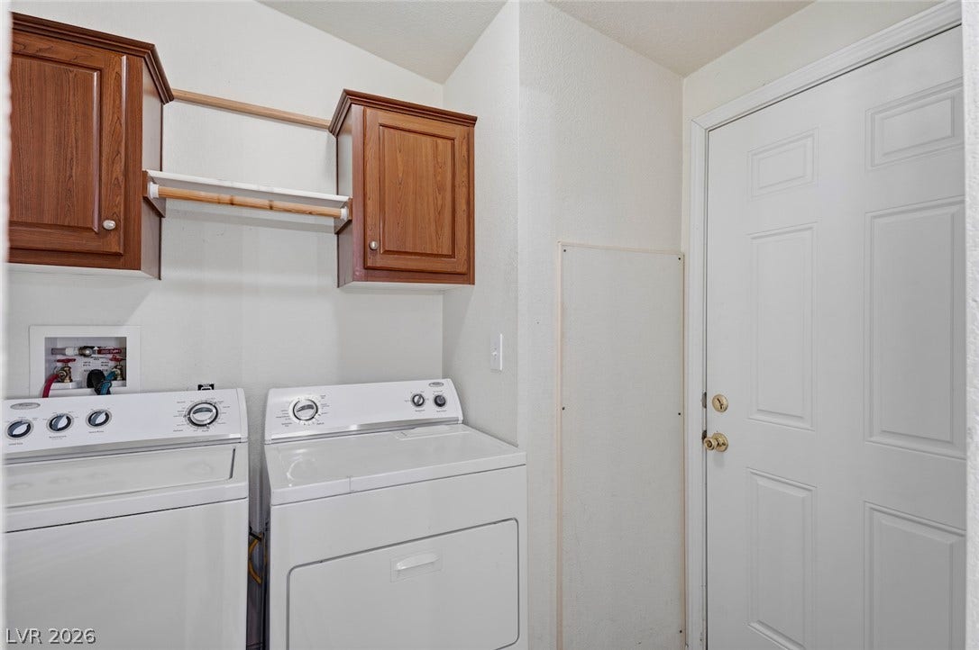 4589 Royal Ridge Boulevard, Las Vegas, NV 89103 A well-appointed laundry area offers convenient access and functional storage for everyday needs.