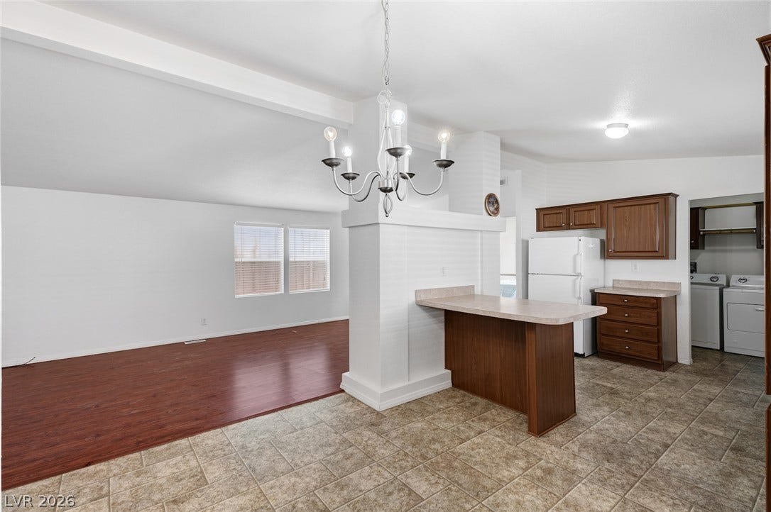 4589 Royal Ridge Boulevard, Las Vegas, NV 89103 An open-concept living space blends seamlessly with the kitchen and features warm wood flooring.