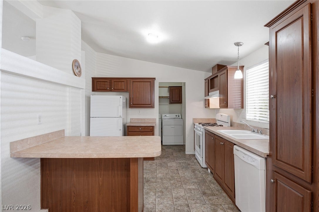 4589 Royal Ridge Boulevard, Las Vegas, NV 89103 Functional kitchen with ample cabinetry and an integrated laundry area offers everyday convenience.