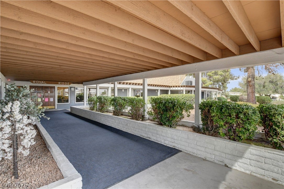 4589 Royal Ridge Boulevard, Las Vegas, NV 89103 A welcoming covered walkway leads to the entrance, flanked by neat hedges and low brick planters.