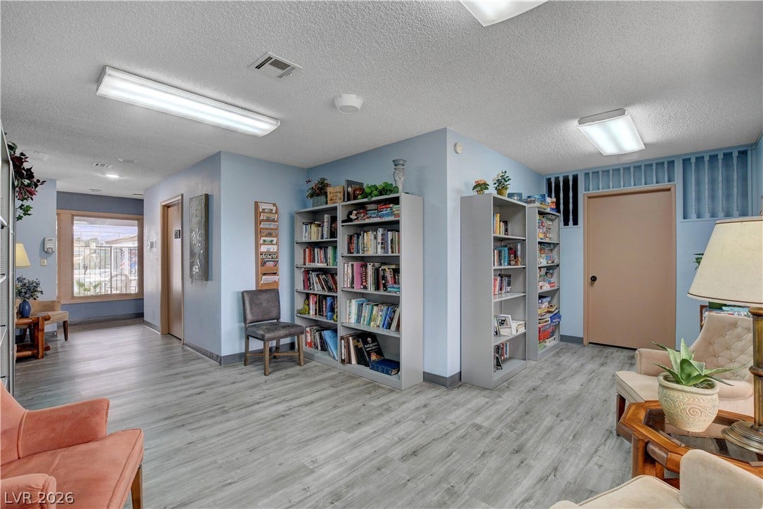 4589 Royal Ridge Boulevard, Las Vegas, NV 89103 A well-lit common area features durable flooring and abundant shelving, perfect for a community library or shared lounge.