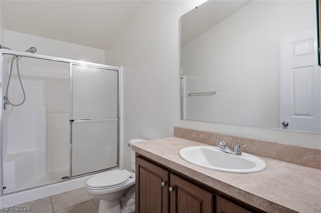 4589 Royal Ridge Boulevard, Las Vegas, NV 89103 A well-maintained bathroom with a spacious vanity, walk-in shower, and ample counter space.