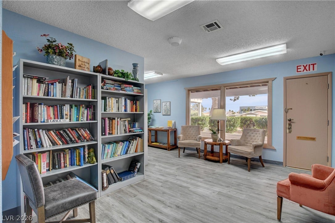 4589 Royal Ridge Boulevard, Las Vegas, NV 89103 A quiet reading nook awaits, complete with extensive built-in shelving and soft, ambient lighting.