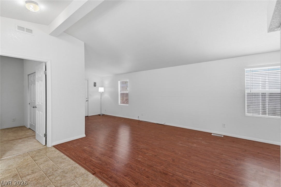 4589 Royal Ridge Boulevard, Las Vegas, NV 89103 A naturally illuminated living room featuring rich wood flooring