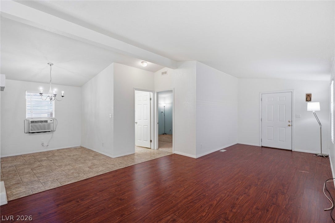 4589 Royal Ridge Boulevard, Las Vegas, NV 89103 Rich wood and tile flooring define distinct areas within this open living space.