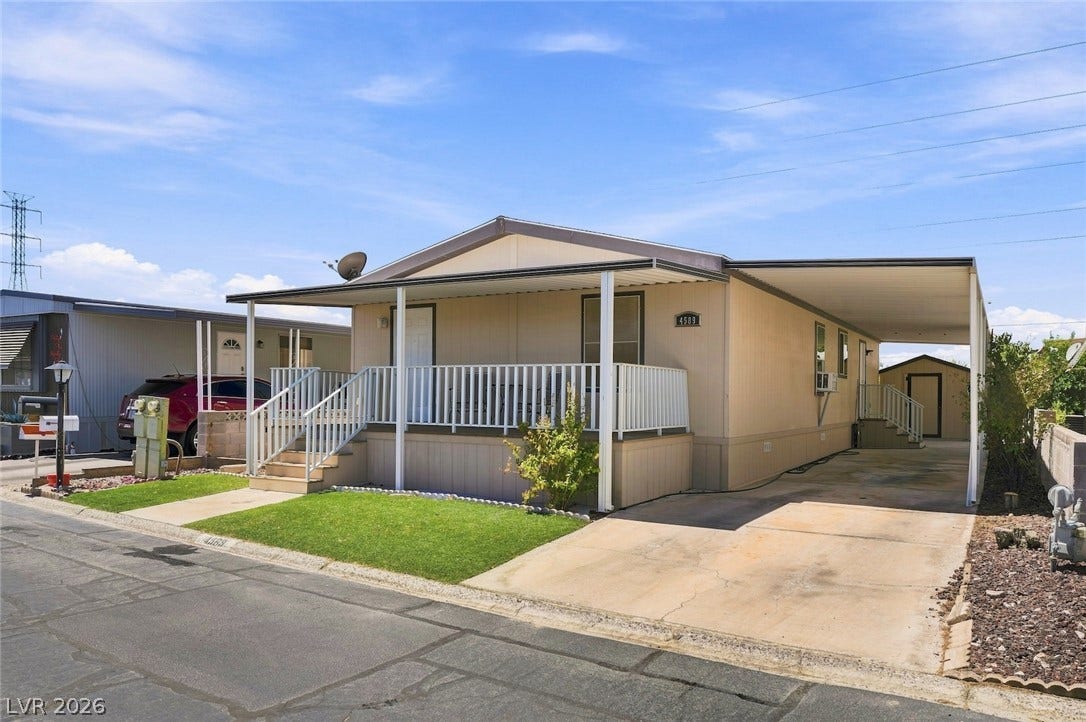 4589 Royal Ridge Boulevard, Las Vegas, NV 89103 A well-maintained manufactured home with a welcoming covered porch and ample driveway space.