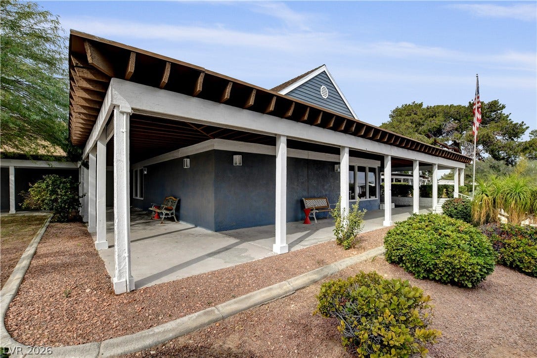 4589 Royal Ridge Boulevard, Las Vegas, NV 89103 A welcoming covered walkway extends along the structure, offering shaded outdoor access and curb appeal.