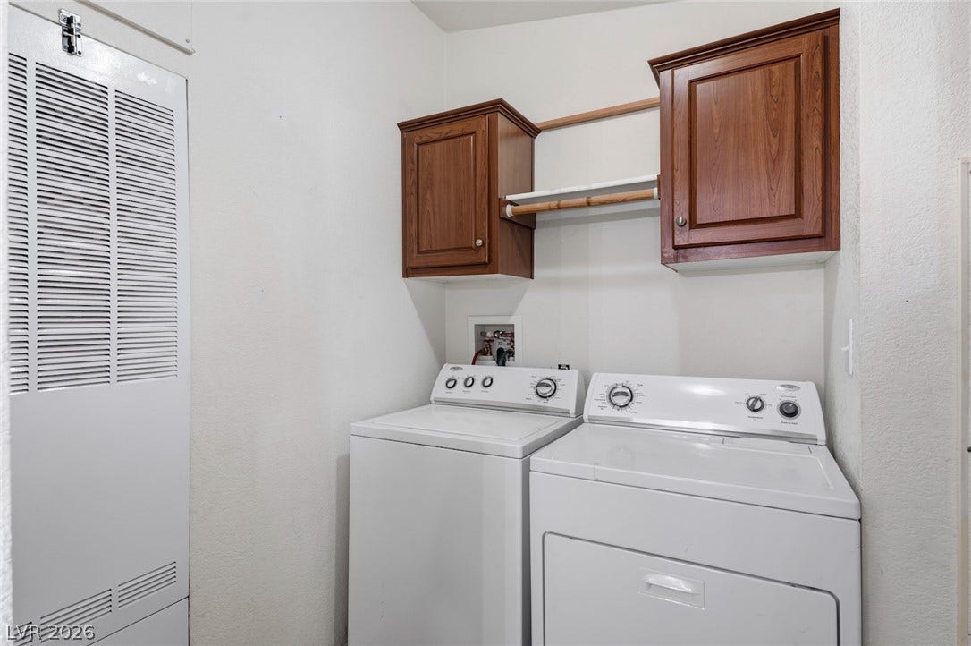 4589 Royal Ridge Boulevard, Las Vegas, NV 89103 Functional laundry space featuring convenient overhead cabinetry and a hanging rod for everyday use.