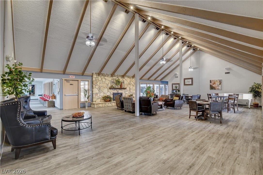 4589 Royal Ridge Boulevard, Las Vegas, NV 89103 A spacious community lounge boasts vaulted ceilings, a stone fireplace, and abundant natural light.